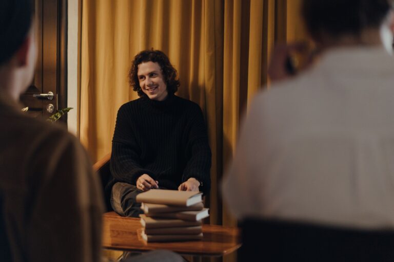 A writer discusses his book with an audience during a creative evening at a cozy bookstore.
